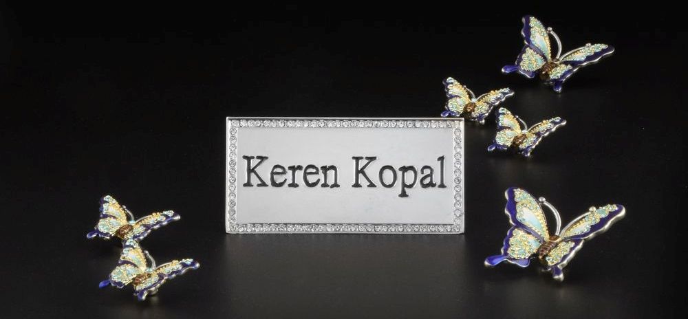 Crystal-embellished butterflies around a Keren Kopal plaque